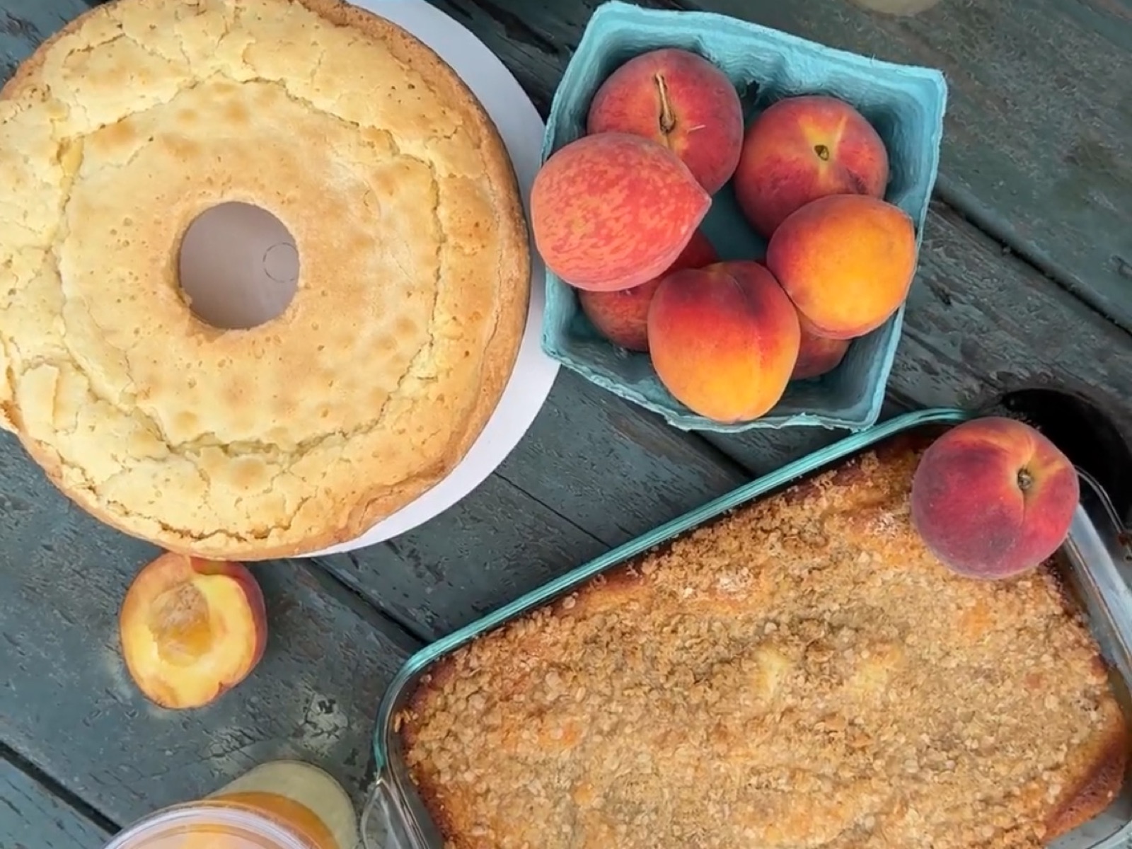 Phillips Farms of Cary — fresh peaches, peach pound cake, and peach cobbler on a rustic wood table
